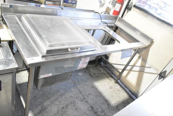 Stainless steel commercial work table with drop-in, 115 volts, 1 phase. Features sturdy construction, integrated power compartment, and visible caution label.