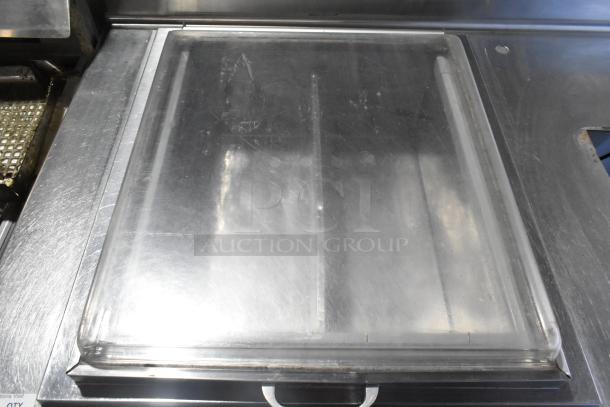 Stainless steel commercial work table with drop-in, 115 volts, 1 phase. Features durable surface, visible wear marks.