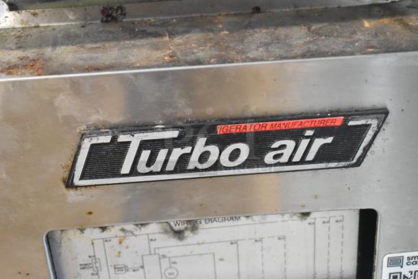 Turbo Air JBT-72 display table with logo, features stainless steel body, commercial casters, and wiring diagram. Signs of wear.