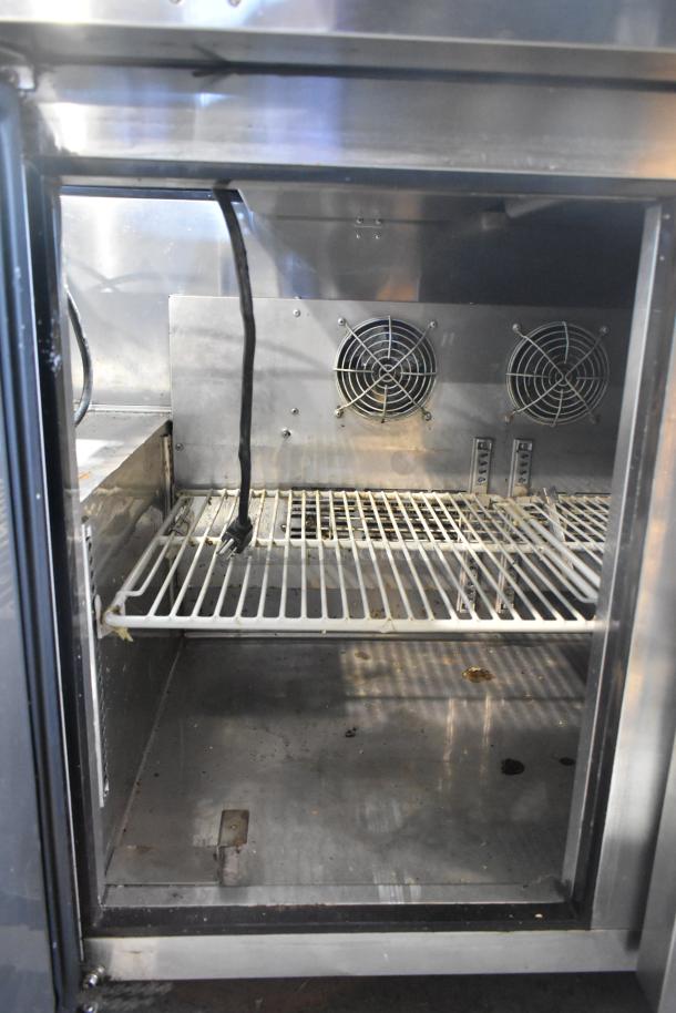 Turbo Air JBT-72 refrigerated buffet table interior with shelves. Features stainless steel, dual fans; shows used condition.