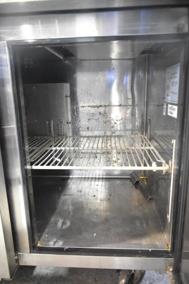 Turbo Air JBT-72 refrigerated buffet table, stainless steel, commercial casters, 115V, 1 Phase. Interior shows wear.