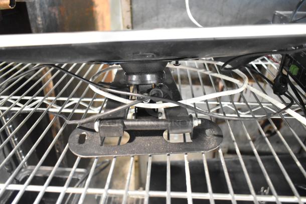 Toast POS monitor with mount and cables on a metal rack. Auction includes additional devices: 3 Epson printers, 2 Toast card scanners, cash drawer, Episode ECA-70MIXAMP-1-60.