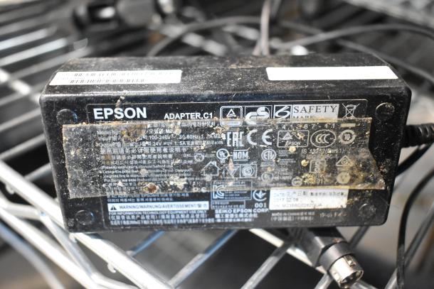 Epson adapter C1 with visible wear and multiple safety certifications, part of a 9-item auction lot.