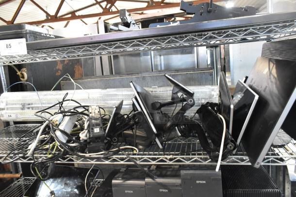 Eight various POS monitors including Toast and Elo models, Samsung S22D300HY computer monitor, assorted cables visible.