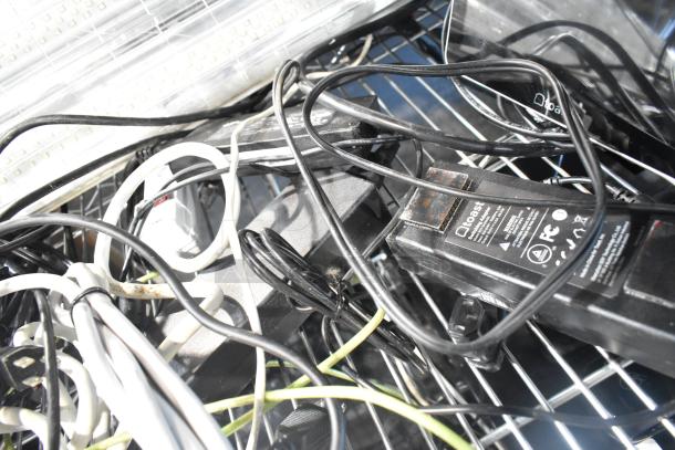 Lot of POS monitors including Toast and Elo, Samsung S22D300HY Monitor. Mixed cables and adapters visible.