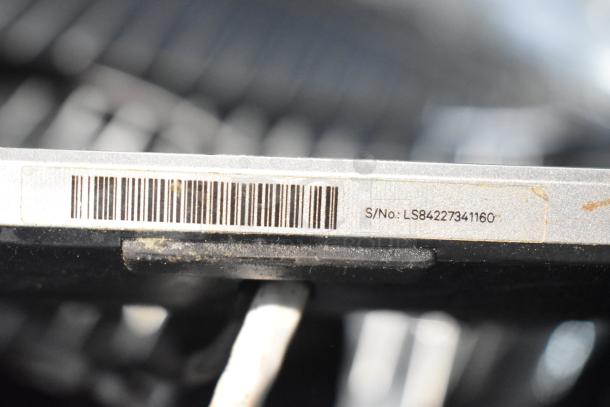 Barcode and serial number label on a monitor. Text shows "S/No: LS84227341160". Condition appears used.