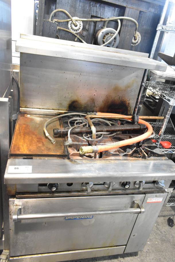 Imperial IR4-612 stainless steel commercial gas griddle with 4-burner range, oven, over shelf, and backsplash; shows wear.