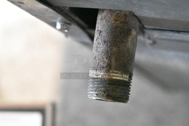 Close-up view of a rusted pipe fitting from the Imperial IR4-612 commercial griddle. Visible wear and corrosion.