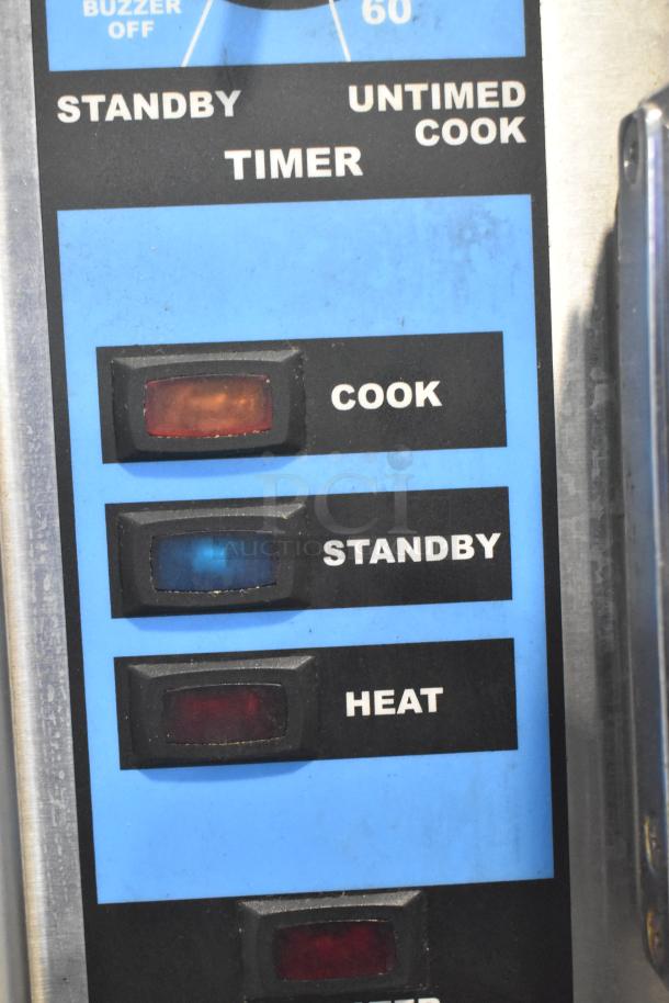 Close-up of Intek Xtreme Steam XSG-5 control panel showing Cook, Standby, and Heat buttons with operational indicators.