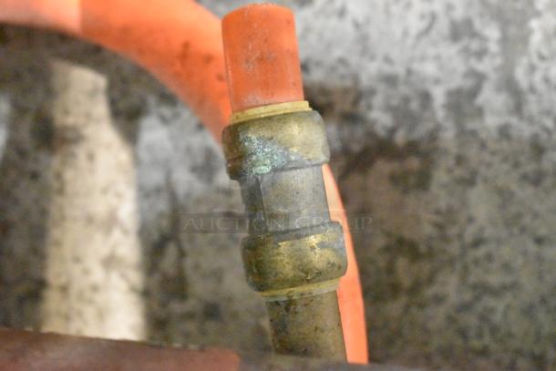 A close-up of a gas pipe and metal fitting in a Rosito Bisani CPG1 pasta cooker, showing signs of use and wear.