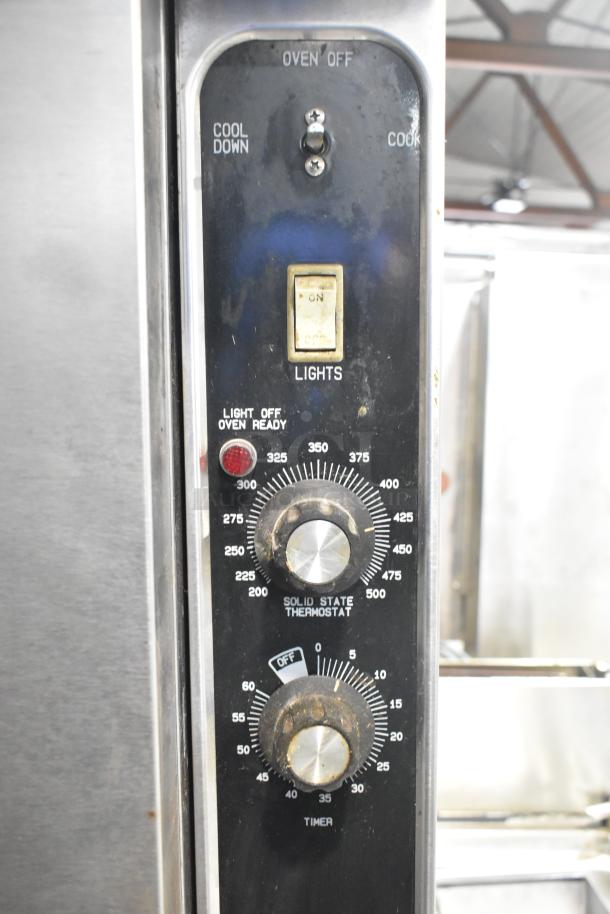 Blodgett stainless steel commercial gas convection oven controls showing temperature and timer dials, with on/off switch.