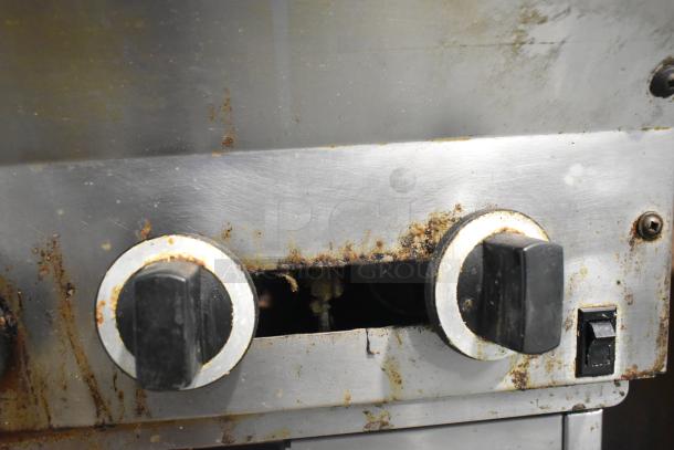 US Range stainless steel 6 burner commercial gas range with oven. Features include over shelf, backsplash. Used condition.