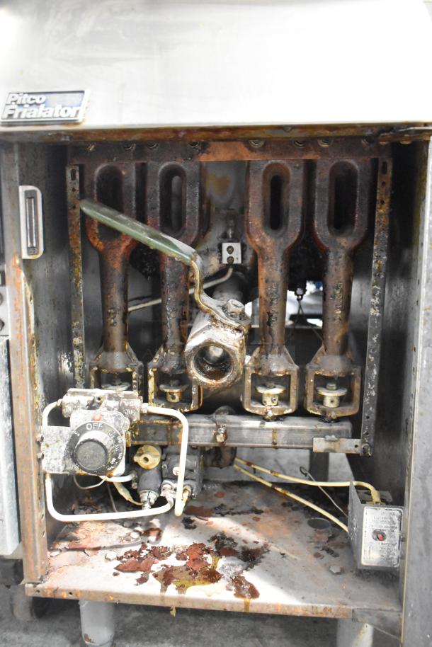 Pitco Frialator 14S stainless steel natural gas deep fat fryer; visible wear and rust; control knob with markings.