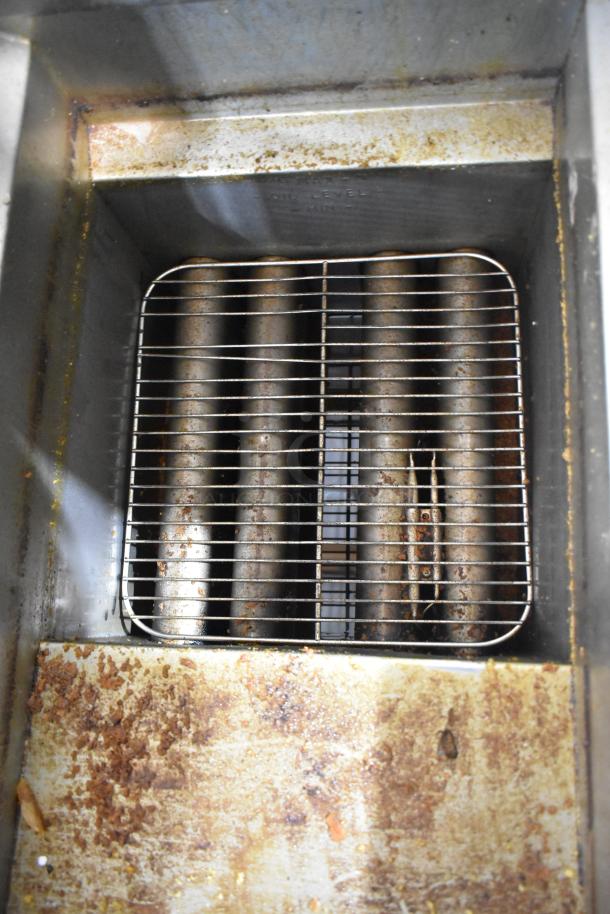Pitco Frialator 14S stainless steel natural gas deep fat fryer; shows wear. Visible oil residue, grid, and heating elements.