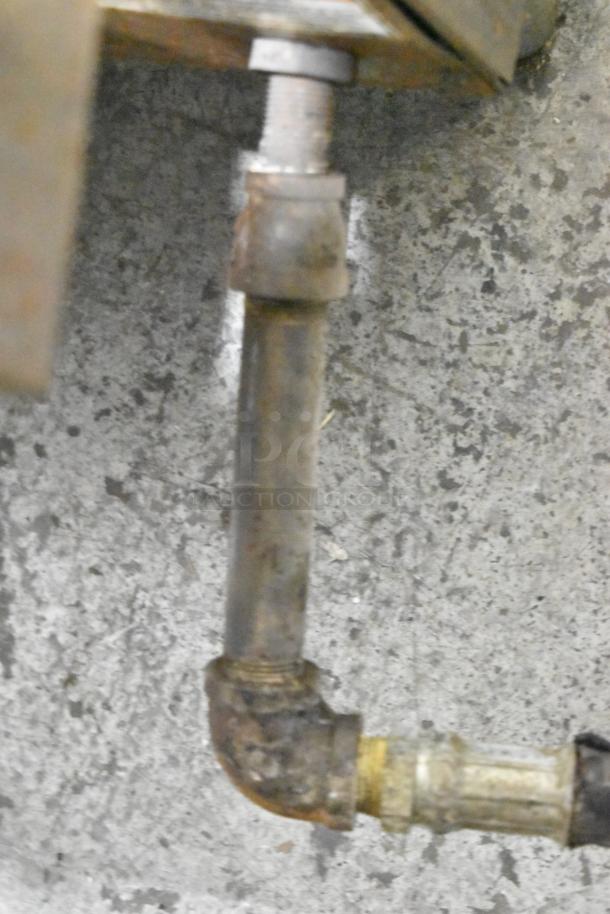 Natural gas pipe connection for Pitco Frialator 14S deep fryer, showing the metal piping and fittings in used condition.