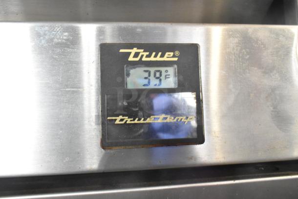 True TS-49 cooler digital temperature display at 39°F, stainless steel finish, model labeling.