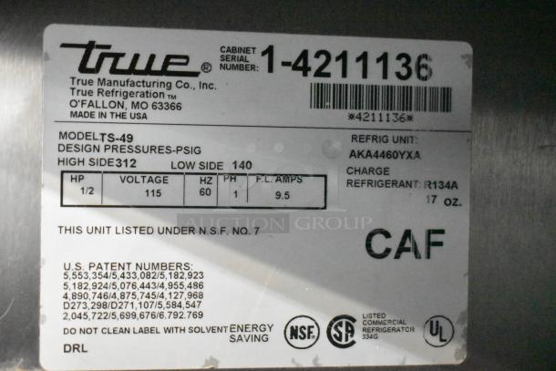 True TS-49 stainless steel cooler label, showing model, voltage, refrigerant type, and certification details.