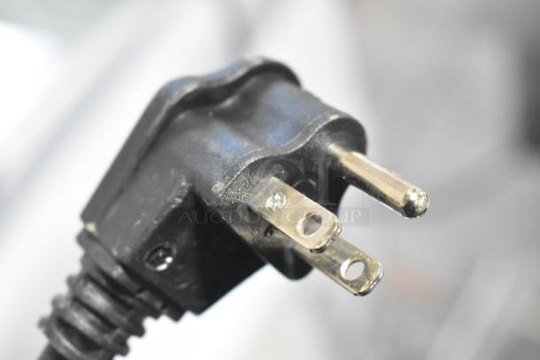 Close-up of a black, three-prong electrical plug for the Vollrath VBBE4-37-F beverage dispenser.