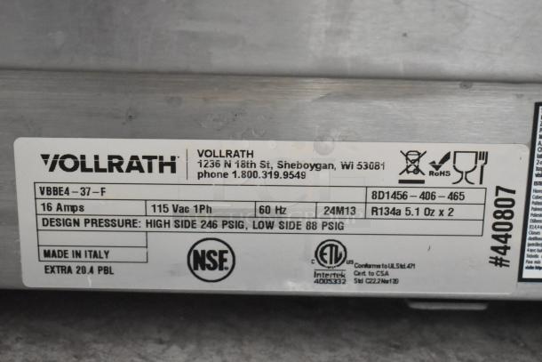 Label on Vollrath VBBE4-37-F beverage dispenser showing electrical specs: 115V, 1Ph, 60Hz. Design pressure: 246 PSIG high, 88 PSIG low. Made in Italy.