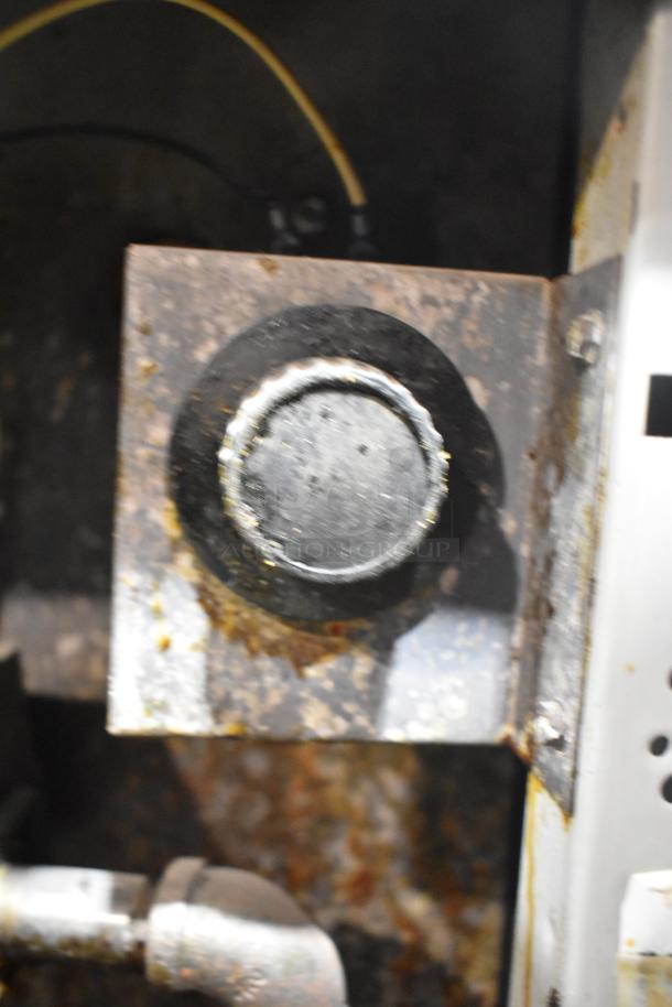 Close-up of a Frymaster GF40SD fryer knob, showing signs of wear. Stainless steel, natural gas powered, 122,000 BTU.