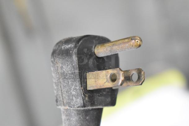Close-up of electrical plug from Glenco SLGS-48-TE 2-Door Reach-In Cooler, 115V, showing slight wear.