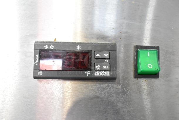 Arctic Air AF23 freezer control panel with Dixell display and power switch, showing temperature and settings on stainless steel surface.