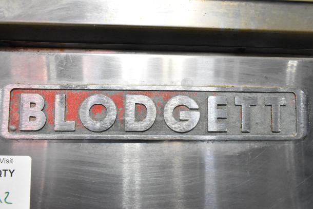 Blodgett logo on stainless steel commercial convection oven. Features solid doors, metal racks, thermostatic controls, casters.