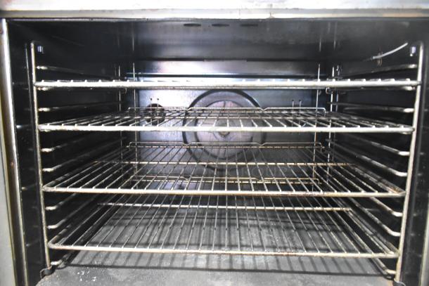 Blodgett stainless steel commercial convection oven interior with metal racks. Features thermostatic controls and casters.