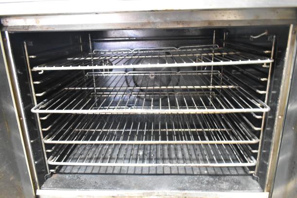 Blodgett stainless steel commercial gas convection oven with metal racks and thermostatic controls.