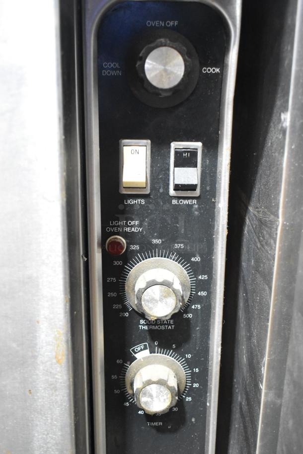 Blodgett convection oven control panel with thermostatic controls, dials for temperature and timer, and light indicators.