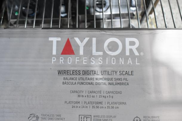 Brand new Taylor TE30WD 30 lb. stainless steel scale with wireless digital display and touchless tare, slight dents shown.