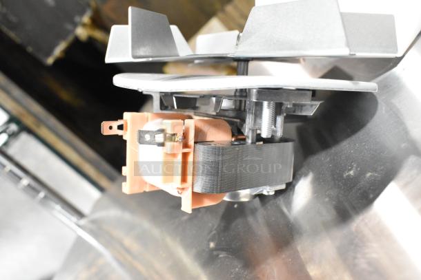 Brand new scratch and dent metal convection oven fan, featuring robust metal blades and a compact motor unit; ideal for efficient heat distribution.