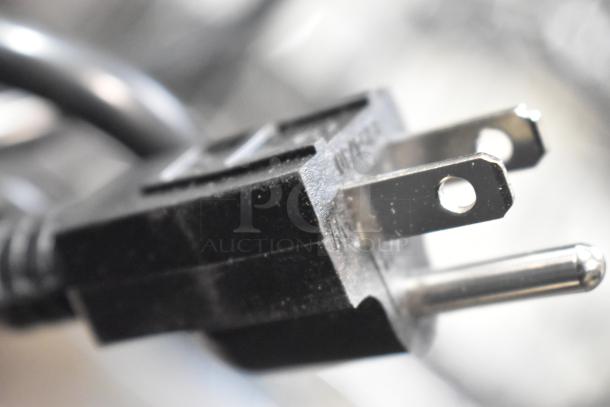 Close-up of a black electrical plug for Avantco 177CPO16TS pizza oven, showing prongs and slight surface texture.