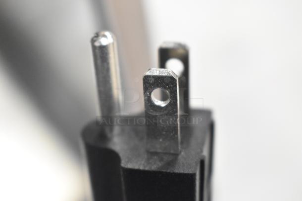 Close-up of a power plug for the 2025 VitaMix VM0800 Stainless Steel Mix'n Mixer, showing three metal prongs.