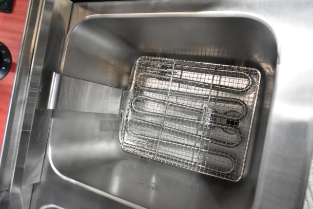 Brand new Avantco 177F202 stainless steel 30 lb. electric countertop fryer, dual tank, with metal fry basket visible.