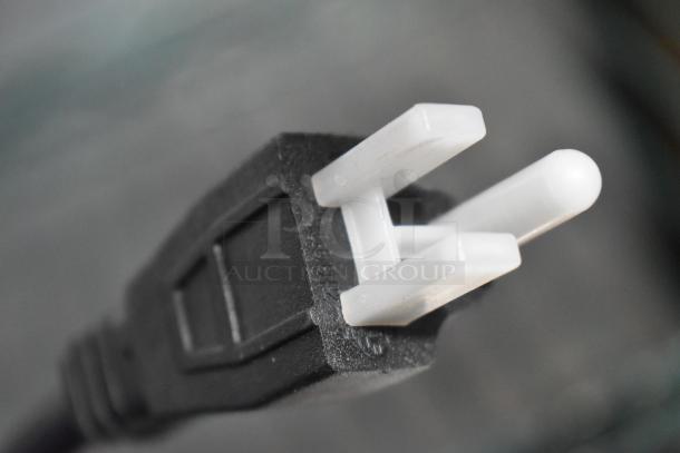 Close-up of a black and white plug for the AvaMix DM-B-30C drink mixer. Plug is intact and clean.