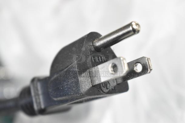 Close-up view of the power plug for a CK2527B316 metal commercial 2 head heat lamp, 120 volts, 1 phase.