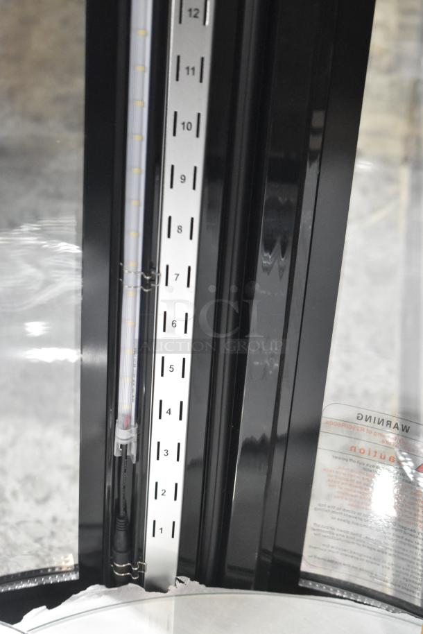 Avantco BCR-15-HC black circular refrigerated display case, showing interior LED light gauge and partial product warning label.