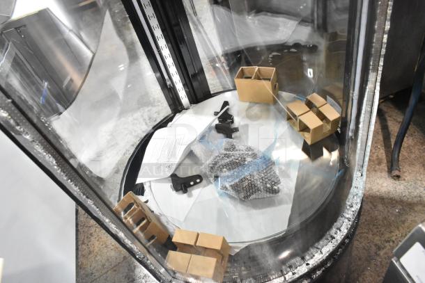 Brand new Avantco 193BCR15HCB black circular refrigerated display case, 115V, with broken glass visible.