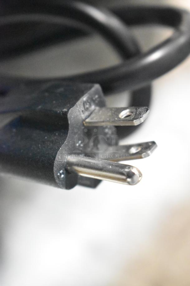 Close-up of a power plug for Avantco 193BCR15HCB Refrigerated Display Case. Black casing, standard prongs visible.