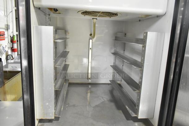 True TA1DT-2HS stainless steel two half-door commercial cooler, interior with shelving, commercial casters, 115V, 1 phase.