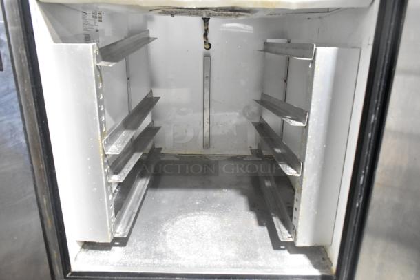 True TA1DT-2HS stainless steel reach-in cooler interior with shelving. Commercial casters; 115V, 1-phase. Great condition.