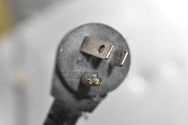 Close-up of a power plug for Delfield 406CA-DHL-DD1 cooler, 115 volts, 1 phase, showing slight wear.