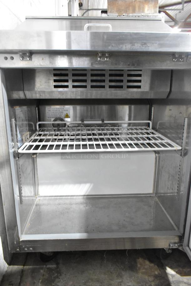 Avantco 178APT27HC stainless steel prep table with bain marie top, features commercial casters and visible interior grates.