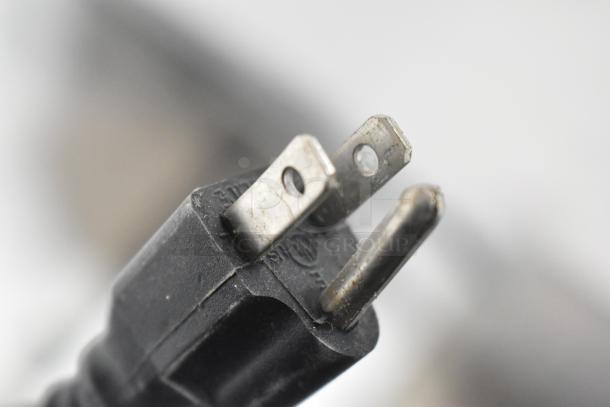 Close-up of a three-prong electrical plug, part of the Avantco 178APT27HC Commercial Prep Table, 115 Volts, 1 Phase.