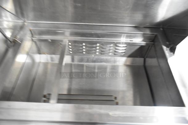 Avantco 178APT27HC stainless steel sandwich salad prep table interior, showing spacious compartment and sleek finish.