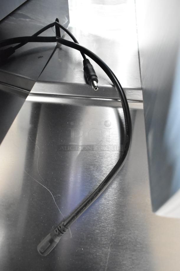 BRAND NEW Beverage-Air LBD3-48L liquor display, 48" three-tiered, LED-lit, minor scratches, power cable shown.