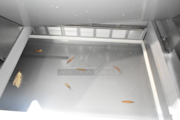 Beverage Air SPE72HC-30M 72" sandwich prep table interior, stainless steel, visible debris, scratch and dent condition.