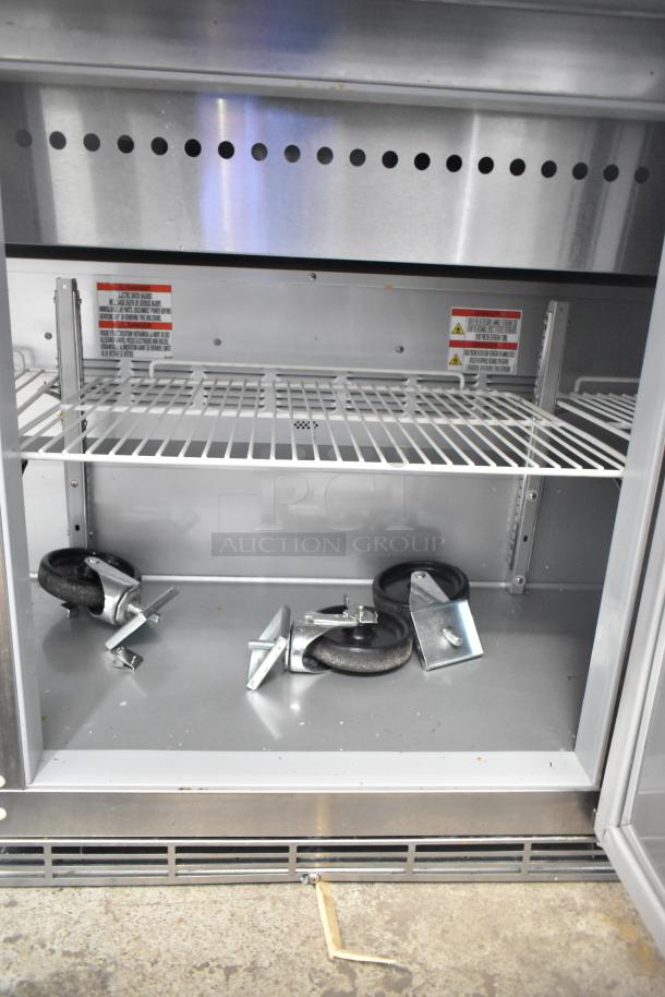 Brand new Beverage Air SPE72HC-30M 72" 3-door refrigerated sandwich prep table, visible casters, scratch and dent condition.