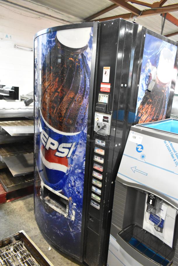 Metal commercial bottle drink vending machine with Pepsi branding, 115 volts, 1 phase. Visible button panel and coin slot.